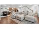 Inviting living room with a large sectional sofa, view to the kitchen, and access to the staircase at 10152 Xanadu St, Commerce City, CO 80022
