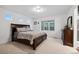 Well-lit main bedroom with a plush bed, dresser, and a neutral color scheme for a calming space at 10152 Xanadu St, Commerce City, CO 80022