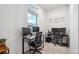 A bright home office features dual workstations, perfect for productivity, and ample natural light at 10152 Xanadu St, Commerce City, CO 80022