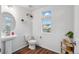 A modern powder room with a pedestal sink, stylish fixtures, and a bright, airy ambiance at 10152 Xanadu St, Commerce City, CO 80022