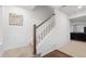 Carpeted staircase with white railing and wooden handrail leads to the upper level at 10152 Xanadu St, Commerce City, CO 80022