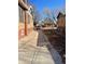 View of the side yard with a driveway and a red vehicle at 1453 Utica St, Denver, CO 80204