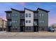 Modern townhome with multiple units featuring a contemporary design and exterior color scheme at 5187 Carr St, Arvada, CO 80002