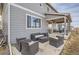 This backyard features a covered patio with outdoor seating and a grill at 4724 S Wenatchee Cir, Aurora, CO 80015