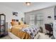 Cozy bedroom with a playful elephant-themed blanket and a large window for natural light at 4724 S Wenatchee Cir, Aurora, CO 80015