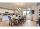 Bright dining area with modern table, seating, and sliding glass doors to the patio at 4724 S Wenatchee Cir, Aurora, CO 80015