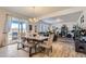 Open dining area with a large table, bench seating, and natural light from sliding glass doors at 4724 S Wenatchee Cir, Aurora, CO 80015