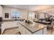 Bright kitchen features a large island, stainless steel appliances, and a view into the dining area at 4724 S Wenatchee Cir, Aurora, CO 80015