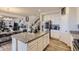 Bright, open kitchen with a central island, stainless steel appliances, and easy access to the dining area at 4724 S Wenatchee Cir, Aurora, CO 80015