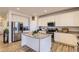 Well-lit kitchen features an island with granite countertops, stainless steel appliances, and white cabinets at 4724 S Wenatchee Cir, Aurora, CO 80015