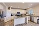 Modern kitchen boasts white cabinets, granite counters, stainless steel appliances, and recessed lighting at 4724 S Wenatchee Cir, Aurora, CO 80015
