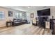 This living room features wood floors, a large TV, a desk, and a reclining couch at 4724 S Wenatchee Cir, Aurora, CO 80015