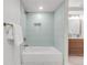 Beautiful bathroom features a tub with modern tile, and a vanity with gold fixtures at 1210 E Colfax Ave # 104, Denver, CO 80218