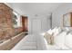 Shot of bed with exposed brick wall and closet in the background at 1210 E Colfax Ave # 104, Denver, CO 80218