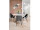 Bright dining area with exposed brick wall and sleek black chairs, modern design at 1210 E Colfax Ave # 104, Denver, CO 80218
