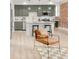 Bright, updated kitchen features stainless appliances, pendant lighting, breakfast bar, and exposed brick at 1210 E Colfax Ave # 104, Denver, CO 80218