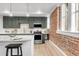 Modern kitchen featuring stainless steel appliances, and exposed brick detailing at 1210 E Colfax Ave # 104, Denver, CO 80218