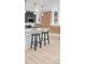 Spacious kitchen island with seating, modern lighting and stainless steel appliances at 1210 E Colfax Ave # 104, Denver, CO 80218