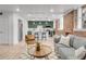 Bright open concept living room into kitchen featuring exposed brick and stainless steel appliances at 1210 E Colfax Ave # 104, Denver, CO 80218