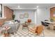 Comfortable living room with exposed brick wall, neutral color palette and hardwood floors at 1210 E Colfax Ave # 104, Denver, CO 80218