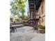 A beautiful outdoor patio features seating, stairs and lush landscaping at 1210 E Colfax Ave # 104, Denver, CO 80218