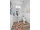 Cozy powder room with wood floors, white fixtures, pedestal sink and decorated with neutral colors at 771 24Th St, Denver, CO 80205