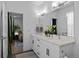 Bathroom vanity with double sinks and white countertops, next to a bedroom and linen closet at 771 24Th St, Denver, CO 80205