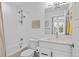 Bright bathroom featuring a shower over tub and single vanity with framed mirror at 771 24Th St, Denver, CO 80205