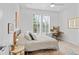 Bright bedroom with a bed, natural light, neutral decor, desk, and wood floors at 771 24Th St, Denver, CO 80205