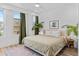 Bright bedroom featuring a large bed, two windows, and stylish decor with light colored walls at 771 24Th St, Denver, CO 80205