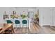 Modern kitchen featuring an island with seating, stainless steel appliances, and an open layout to the living area at 771 24Th St, Denver, CO 80205