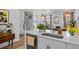 Modern kitchen featuring an island with a sink, white countertops, and stainless steel appliances at 771 24Th St, Denver, CO 80205