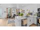Bright and open living space featuring a modern kitchen, comfortable seating, and hardwood floors throughout at 771 24Th St, Denver, CO 80205