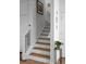 Stairway with wooden treads and white risers, complemented by a black metal railing and artwork at 771 24Th St, Denver, CO 80205