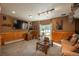 Finished basement Gathering room featuring a large TV and sliding glass doors at 3891 Windchant Cir, Castle Rock, CO 80104