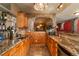 Long granite bar with wood cabinets and wine storage at 3891 Windchant Cir, Castle Rock, CO 80104