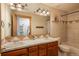 Double vanity bathroom with a shower and tub at 3891 Windchant Cir, Castle Rock, CO 80104