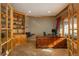 Home office with built-in shelves and hardwood floors at 3891 Windchant Cir, Castle Rock, CO 80104