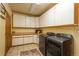 Laundry room with washer, dryer and lots of cabinet space at 3891 Windchant Cir, Castle Rock, CO 80104