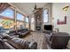 Spacious living room with a stone fireplace and abundant natural light at 3891 Windchant Cir, Castle Rock, CO 80104