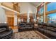 Spacious living room with a high ceiling, large windows, and a cozy seating area at 3891 Windchant Cir, Castle Rock, CO 80104