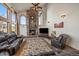 Living area with stone fireplace, hardwood floors, and large windows at 3891 Windchant Cir, Castle Rock, CO 80104