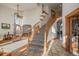 Elegant curved staircase with wood railings and carpet at 3891 Windchant Cir, Castle Rock, CO 80104