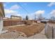 A large, unfenced back yard with some bushes and a storage shed at 8074 Grove St, Westminster, CO 80031