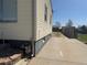Exterior side view shows access to the backyard and the home's siding, window, and utility connections at 8074 Grove St, Westminster, CO 80031