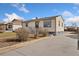 Charming home with a well-manicured lawn, a welcoming porch, and a driveway at 8074 Grove St, Westminster, CO 80031
