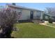 Charming home with a well-maintained lawn and a beautiful lilac bush, adding curb appeal to the property at 8074 Grove St, Westminster, CO 80031