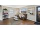 Cozy living room featuring hardwood floors, a comfortable leather couch, and a view of the outdoors at 8074 Grove St, Westminster, CO 80031