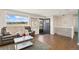 Bright living room with a large window, a comfortable sofa, and stylish decor offers a relaxing space at 8074 Grove St, Westminster, CO 80031