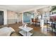 Open concept living room and kitchen with barstool seating and modern decor provide a cozy and inviting space at 8074 Grove St, Westminster, CO 80031